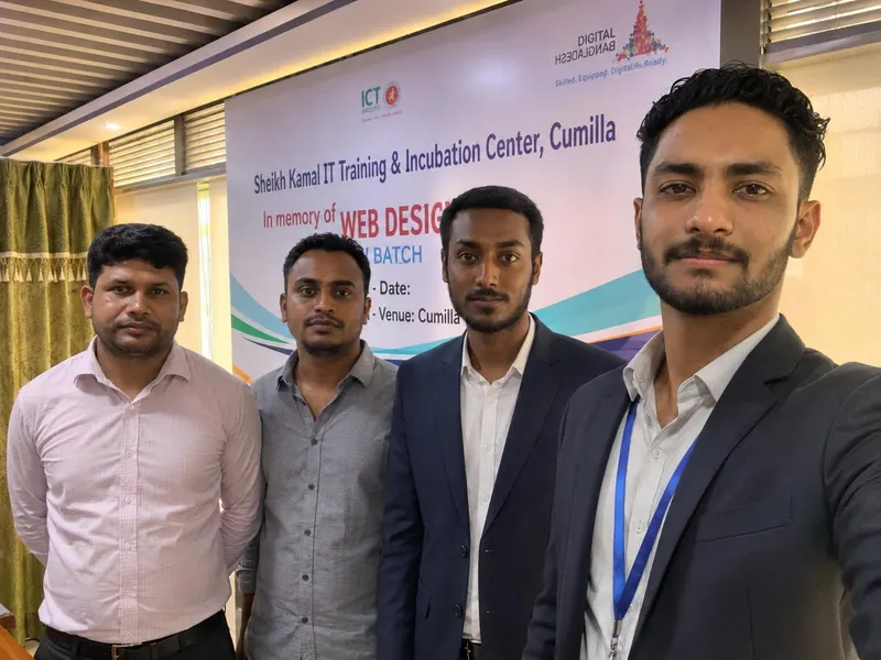 Arafat with three colleagues in front of a web design training banner in Cumilla